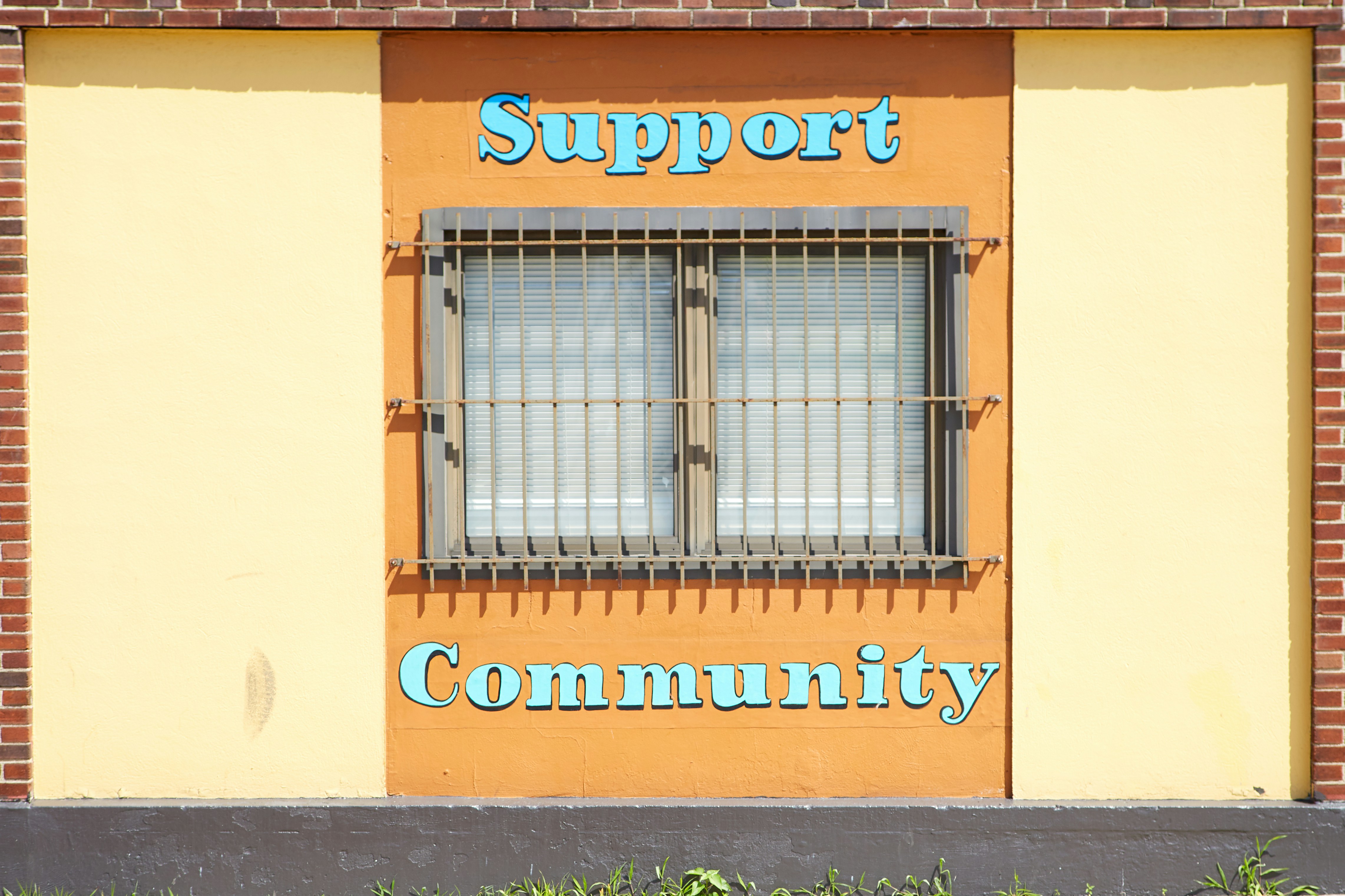 I pass by this building everyday to work. I always thought it was a bit sad the message of ‘support’ and ‘community’ was around the steel bar window.
